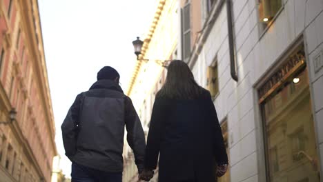 couple holding hands in rome