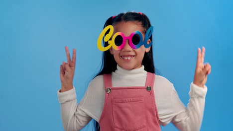 smiling girl with cool glasses making peace sign