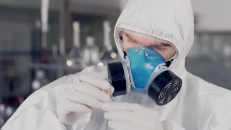 closeup-scientist-in-a-protective-suit-and-a-respirator-conducts-aloe-research