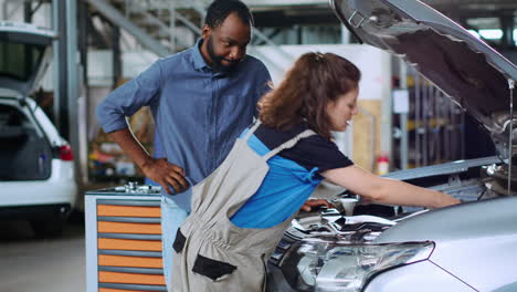 Engineer-in-garage-changes-car-motor-oil