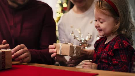 handheld view of family with christmas gifts at home