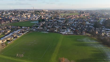 drone's-eye winter view captures dewsbury moore council estate's typical uk urban council-owned housing development with red-brick terraced homes and the industrial yorkshire