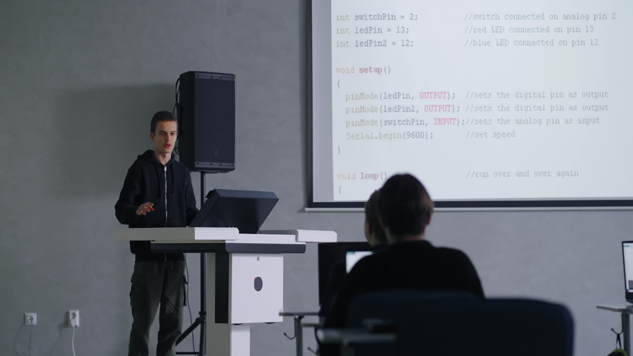 학생이 교실에서 아두이노 코드를 제시하고 있습니다.