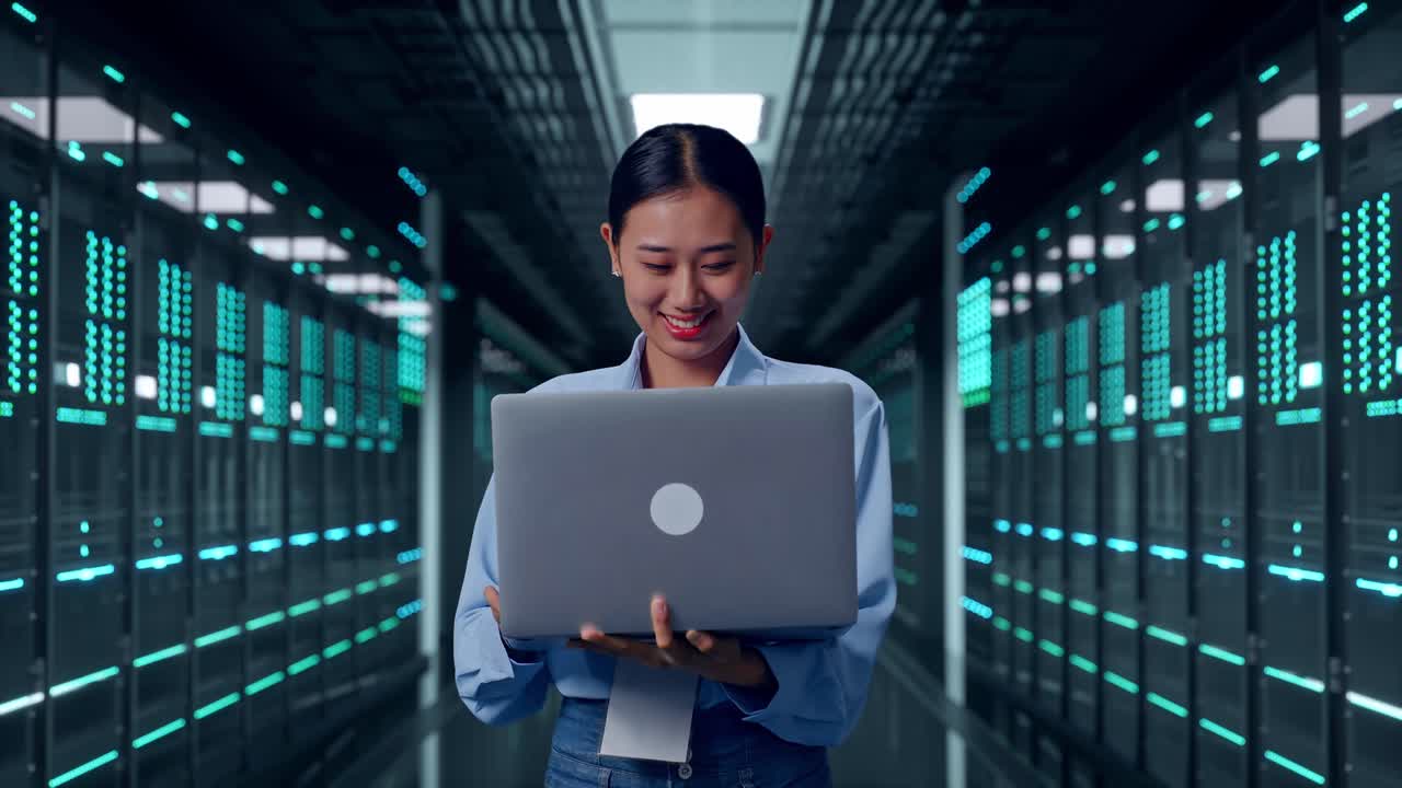 Asian Female With Her Laptop In Server Room Data Center, Work Continuously
