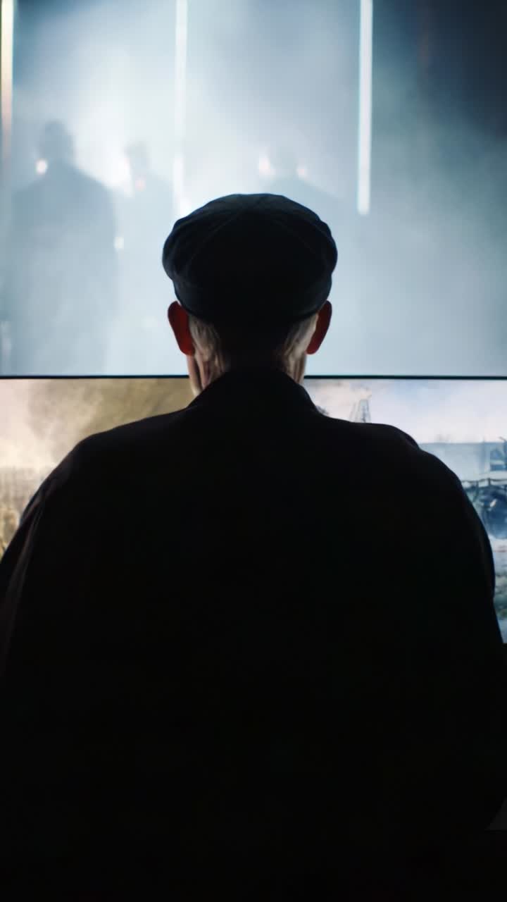An enigmatic figure watches a video screen, casting shadows as misty lights illuminate the background, creating a captivating contrast of presence and technology