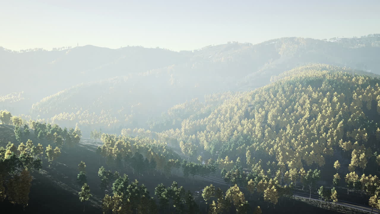 Misty mountains envelop lush greenery during tranquil morning hours