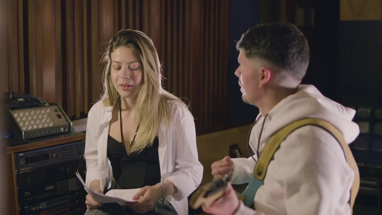 Two musicians working in music studio