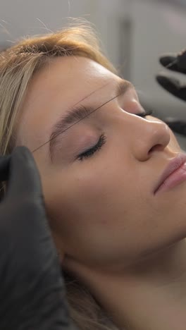 makeup artist makes markings with pencil for lips permanent tattooing