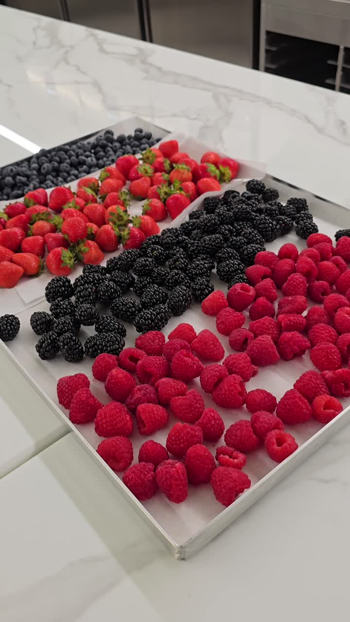 A variety of fresh berries arranged for cake and muffin decorations at a bakery shop