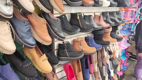 video of shoes for sale in an open air market stand