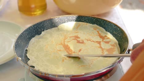 Indian-cook-making-fresh-chapatis-on-a-gas-stove-using-a-tong---cooking-concept