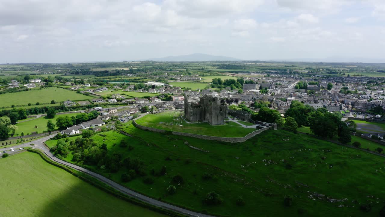 Wide establishing shot of Ireland's Rock of Cashel surrounded by green countryside.