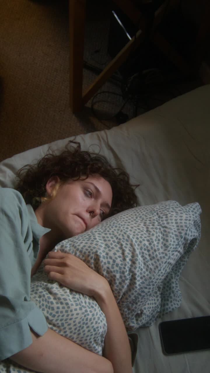 Woman Sleeping Unhappily in Bed
