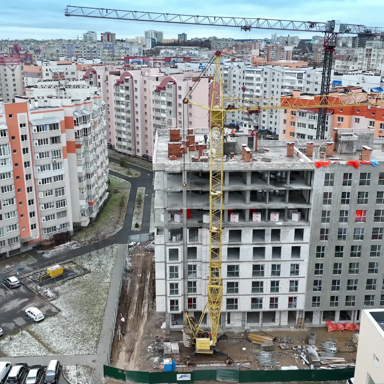 The construction of new high block of flats in the residential area. Densely built new neighborhood with light apartment blocks. Aerial view