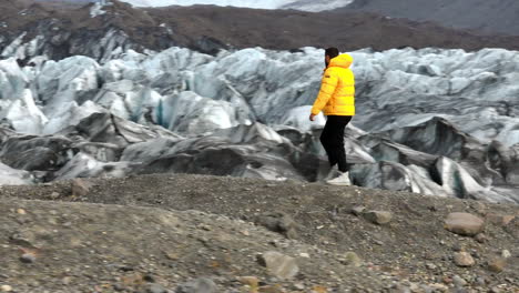 Svinafellsjokull-Glacier,-Iceland---A-Person-Trekking-Across-a-Glacier---Tracking-Shot