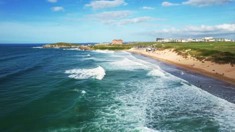 fistral beach views with surfing waves on a summers day in cornwall