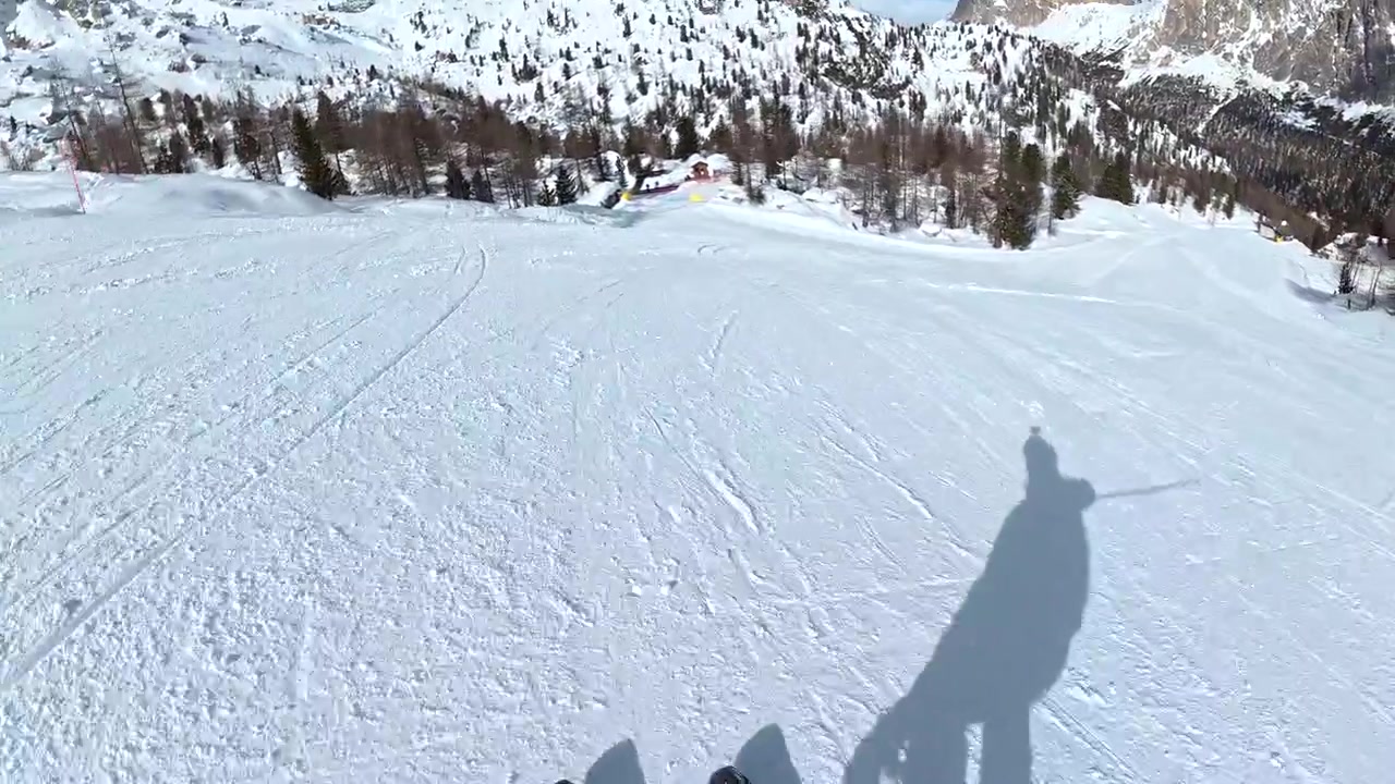 First-Person View of Skier Descending a Snowy Mountain Slope