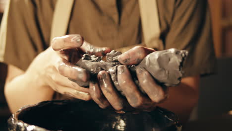 hands kneading clay for pottery