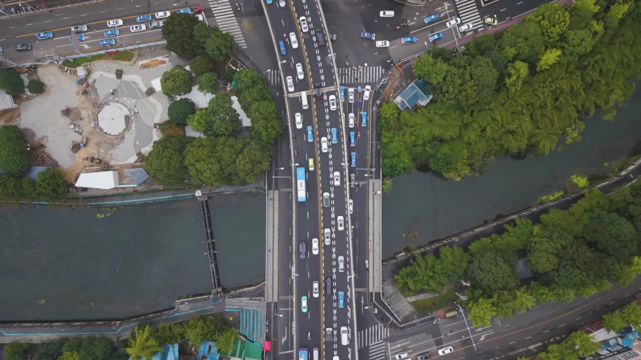 Drone top-down view of busy multilayer highway intersections in Guiyang, Guizhou Province, with dense urban traffic, overpasses and city streets. China, UHD
