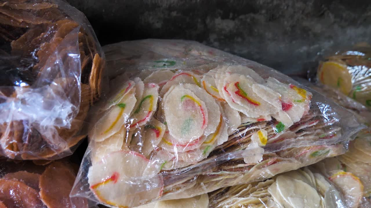 Slow motion shot of raw Krupuk packed in plastic bags in an Indonesian store