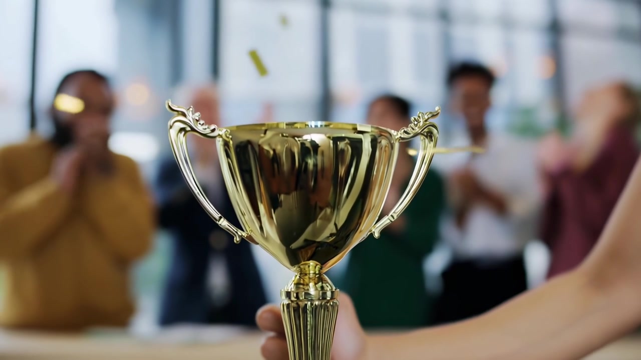 Golden Trophy Awarded to Employee During Business Celebration