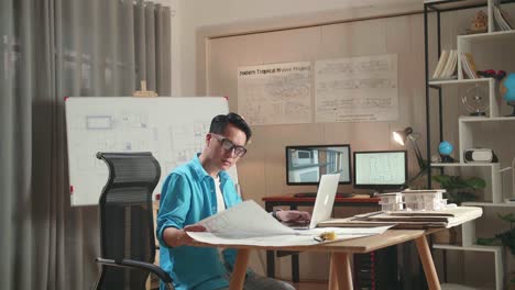 architect reviewing house plans and 3d model