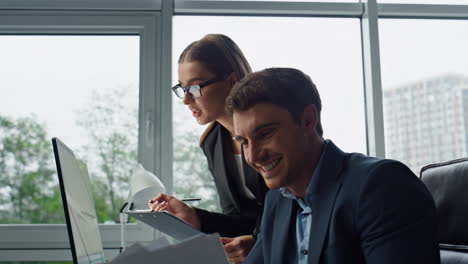 Financial-managers-discussing-project-analysing-data-together-in-office-closeup.