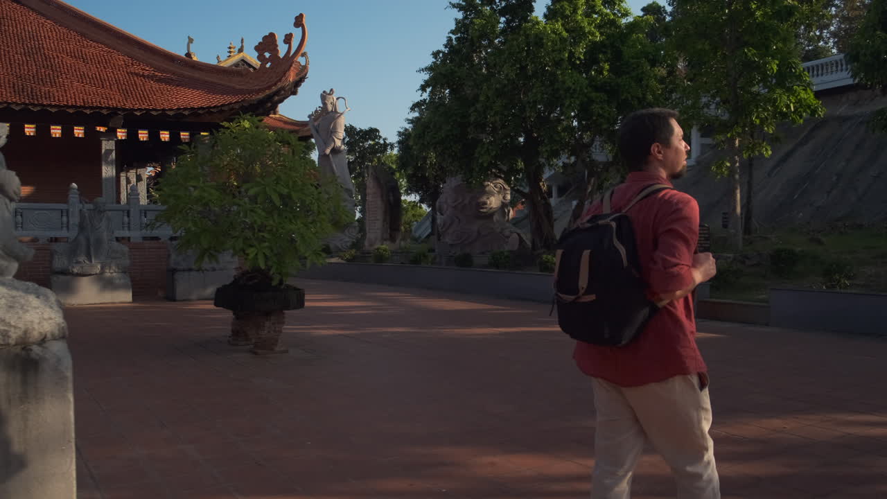 Tourist Walking Through a Temple Garden
