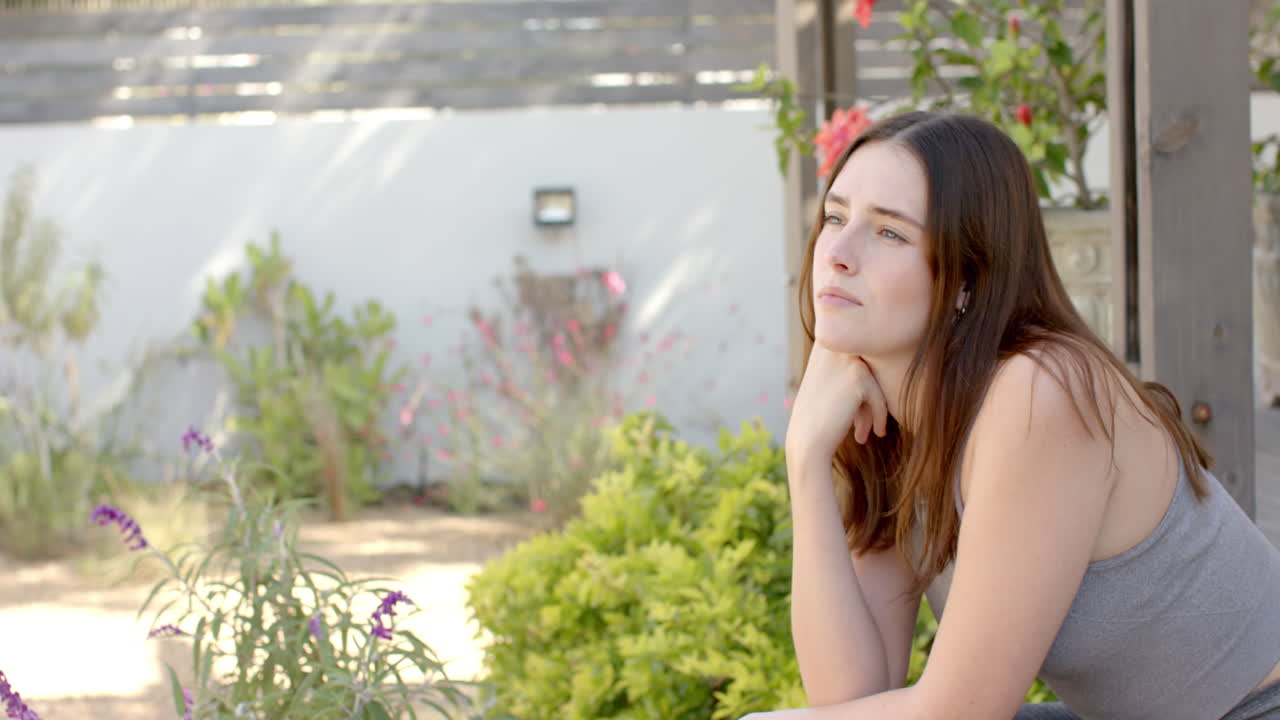 Sitting outdoors, woman relaxing and enjoying nature in garden area, copy space