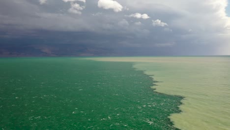 cross-line-in-the-dead-sea,-flood-muddy-water-and-turquoise-water-of-the-dead-sea