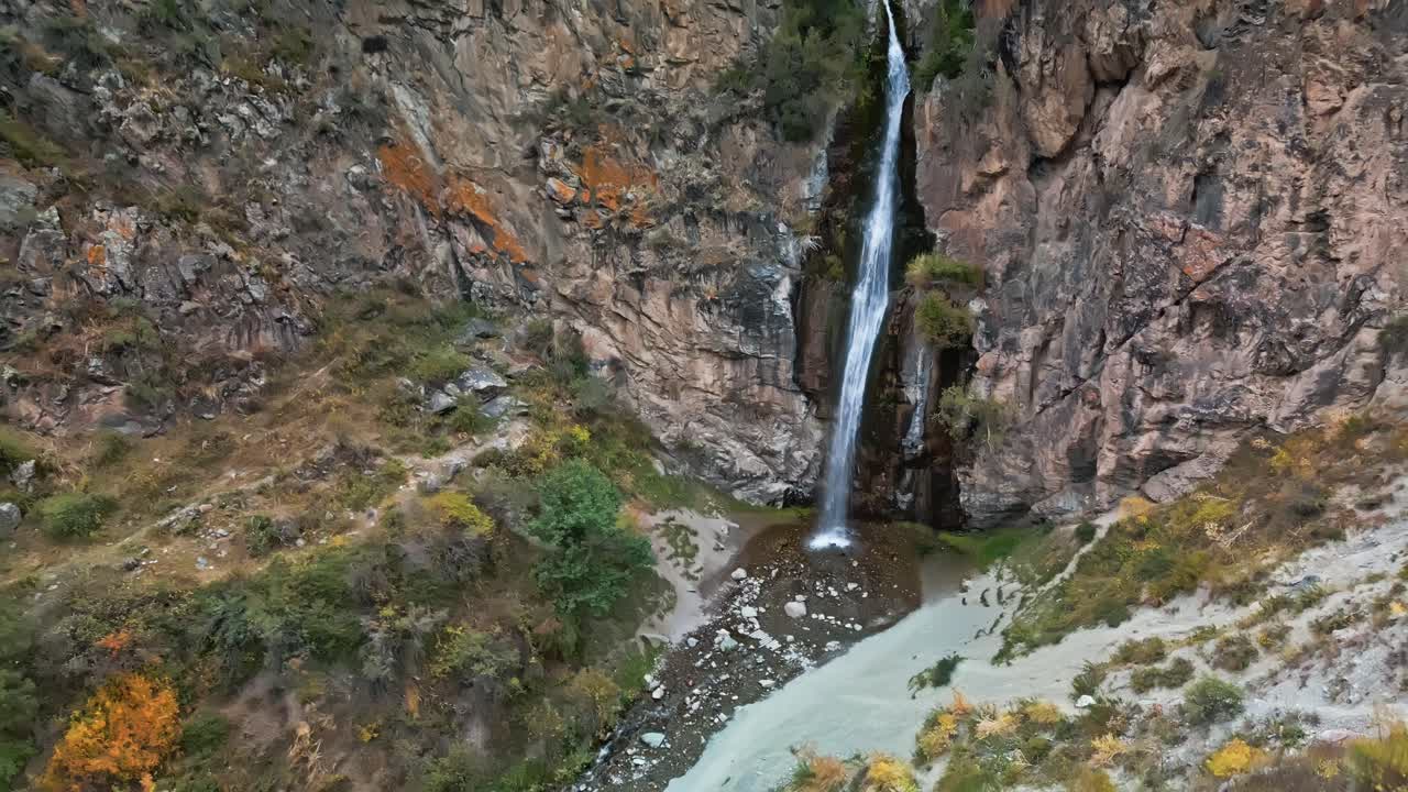 Kyrgyzstan falls, where water calls, down jagged canyon walls