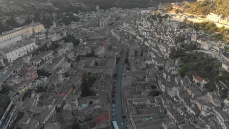 flying over historic town of modica sicily during sunrise, aerial