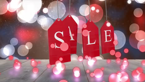 Red-sale-tags-hanging-against-glowing-background