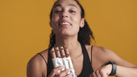 african american happy woman over yellow background.