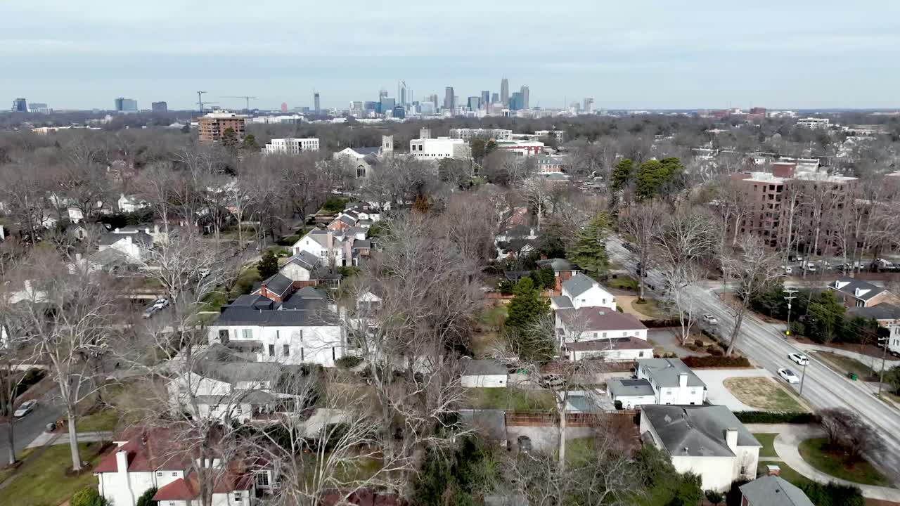 aerial of charlotte skyline with homes in the foreground