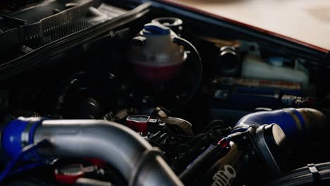 a slow motion parallax shot of the engine hood of a tuning car