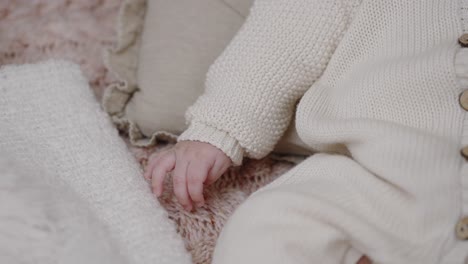 infant baby hand on knitted blanket. close-up