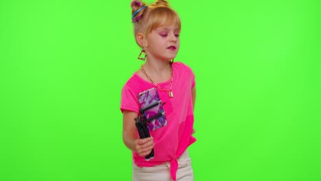 Dancing-young-little-kid-girl-blogger-record-dance-moves-at-camera-for-social-media-content-on-phone