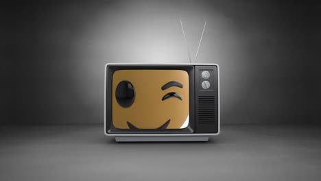 Emoji-De-Cara-Guiñando-Un-Ojo-En-La-Pantalla-Del-Televisor-Contra-Un-Fondo-Gris