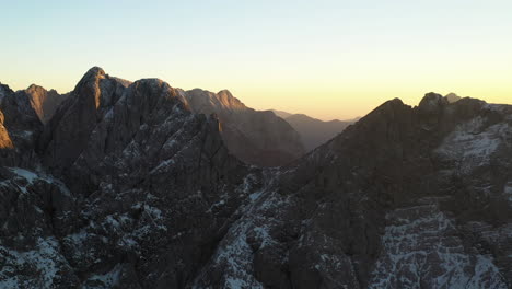 cinematic drone shot of the julian alps of slovenia, with snow covered peaks