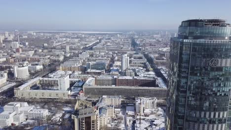 aerial view of a city in winter with a prominent skyscraper