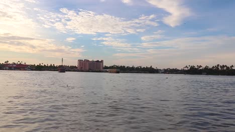 sea backwater with many traditional houseboats running and amazing sky at morning video taken at alappuzha or alleppey backwater kerala india