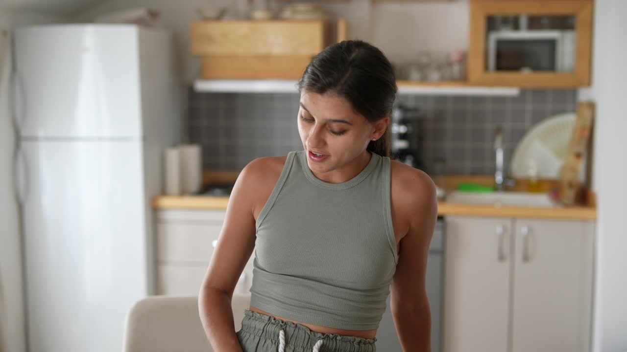 Woman working on laptop in a kitchen