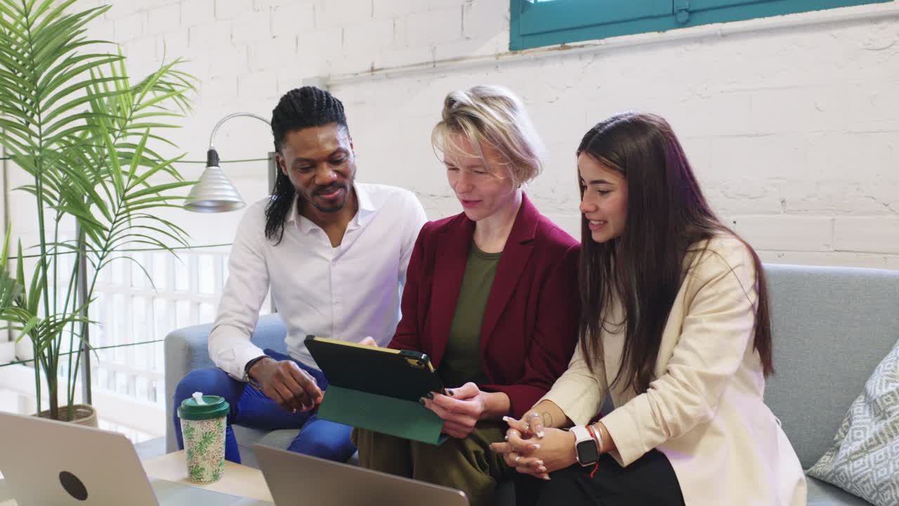 Business team collaborating on a tablet in a modern office