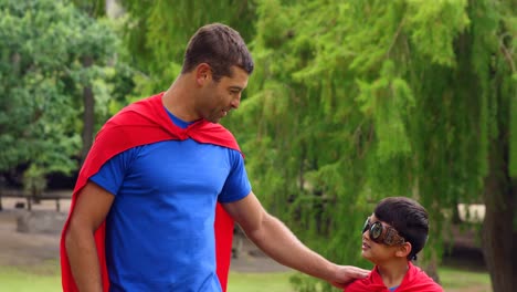 father and son pretending to be superhero