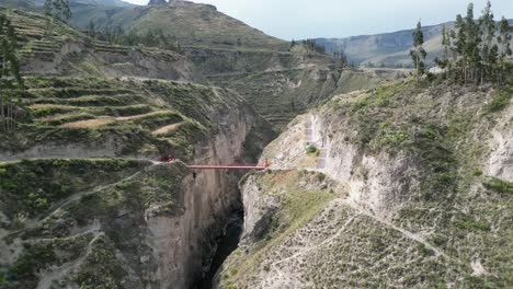 flyover colca canyon footbridge in mountain terraces near yanque, peru