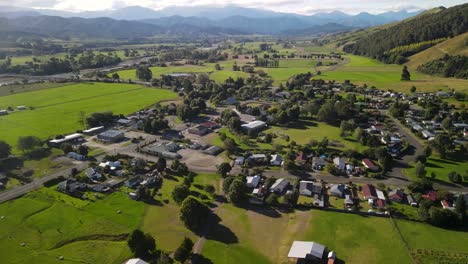 Picturesque-small-town-Tapawera,-shop,-gas-station,public-and-house-buildings-in-river-valley