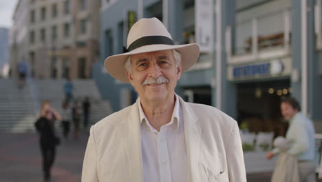 portrait of stylish elderly man tourist smiling cheerful enjoying urban sightseeing travel wearing white suit