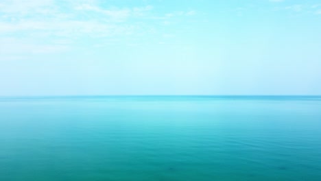 aerial top-down view of the sea surface with deep blue water, moving forward