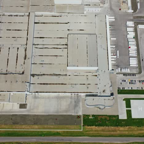 industrial zone on field. view from above on roofs of a modern manufacture with many car parking places. aerial view. slow motion.